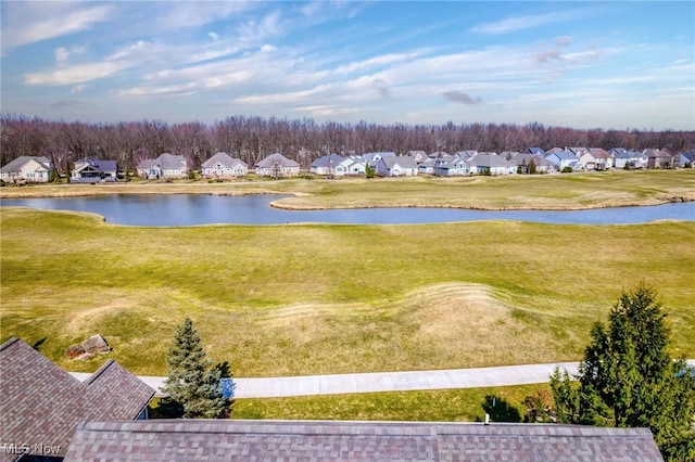 drone / aerial view featuring a residential view and a water view