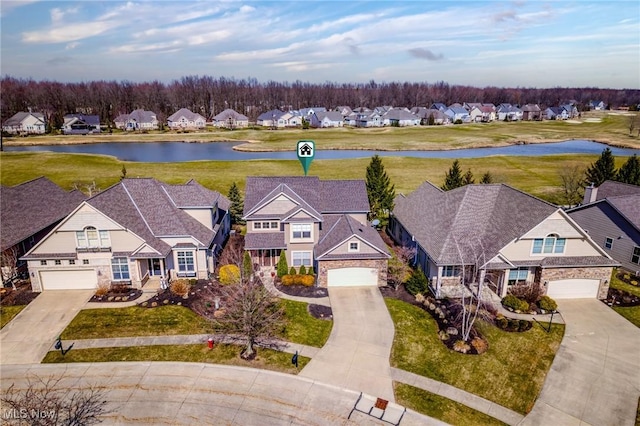 drone / aerial view with a residential view and a water view