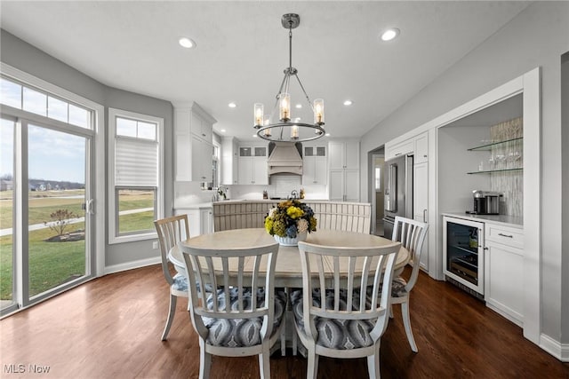 dining room featuring recessed lighting, a chandelier, dark wood-type flooring, and beverage cooler