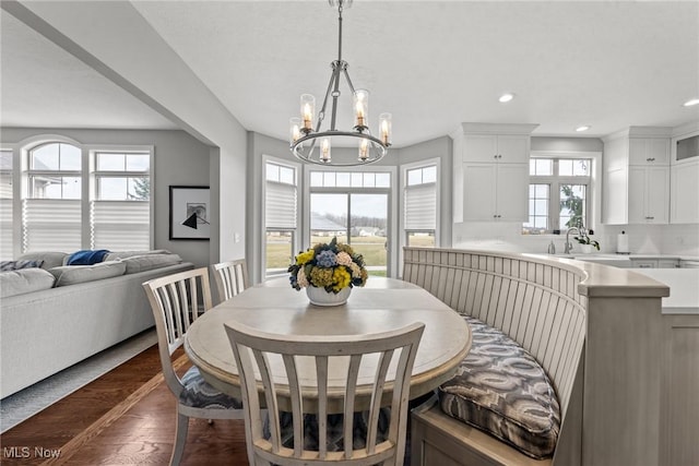 dining area with recessed lighting, a notable chandelier, and dark wood finished floors