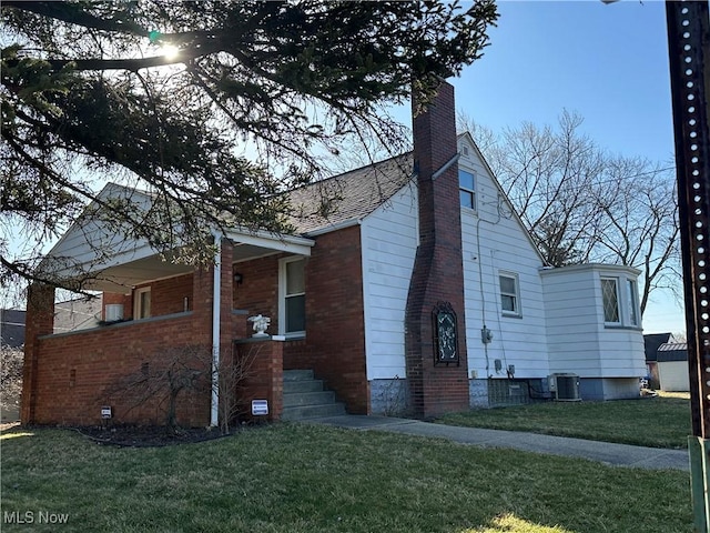 view of property exterior featuring a yard, cooling unit, and a chimney