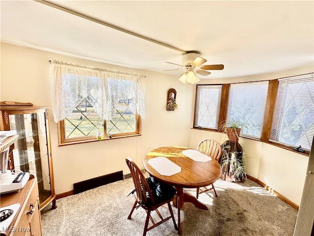 dining area with carpet flooring, baseboards, and ceiling fan