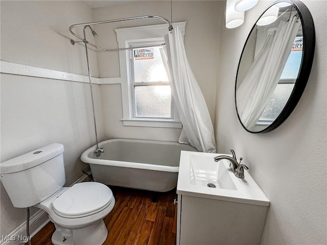 bathroom featuring vanity, toilet, wood finished floors, and shower / bath combo