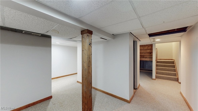 hallway featuring stairs, visible vents, baseboards, and carpet floors