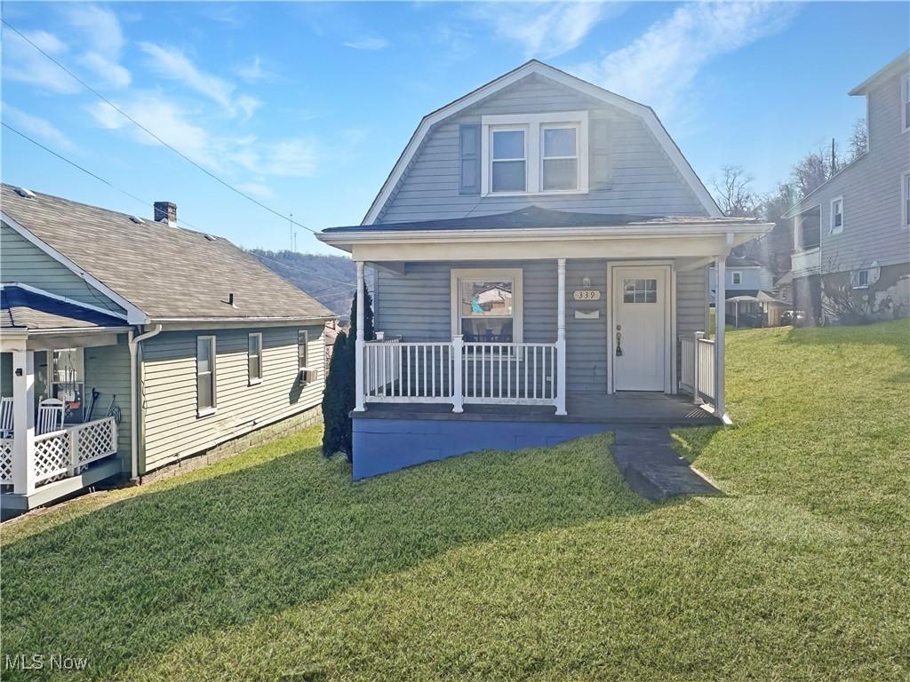 339 Orr St, Weirton, WV 26062 - dutch colonial featuring a gambrel roof, covered porch, and a front lawn