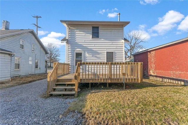 back of house featuring a yard and a wooden deck