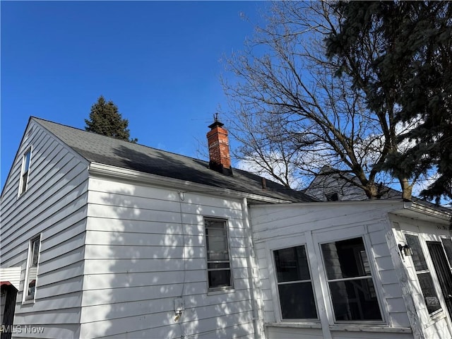 view of property exterior featuring a chimney