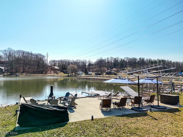 view of dock with a patio area and a water view