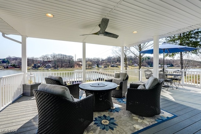 deck featuring a water view and ceiling fan