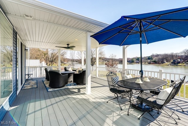 deck with a water view and a ceiling fan