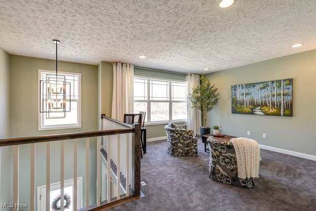 sitting room with recessed lighting, dark carpet, a textured ceiling, and baseboards