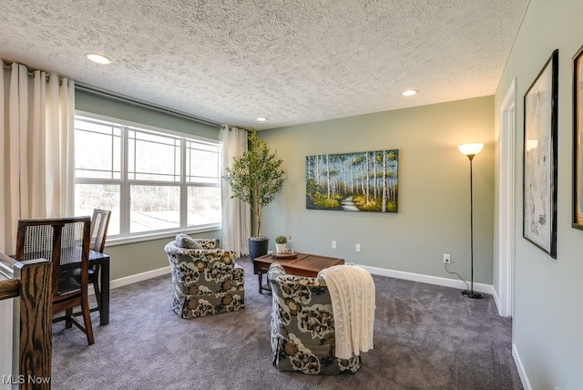 living area with recessed lighting, dark carpet, a textured ceiling, and baseboards