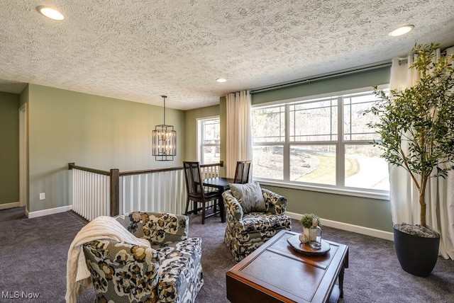 living room featuring carpet, baseboards, recessed lighting, a notable chandelier, and a textured ceiling