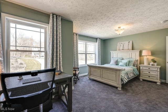 bedroom with baseboards, dark carpet, and a textured ceiling