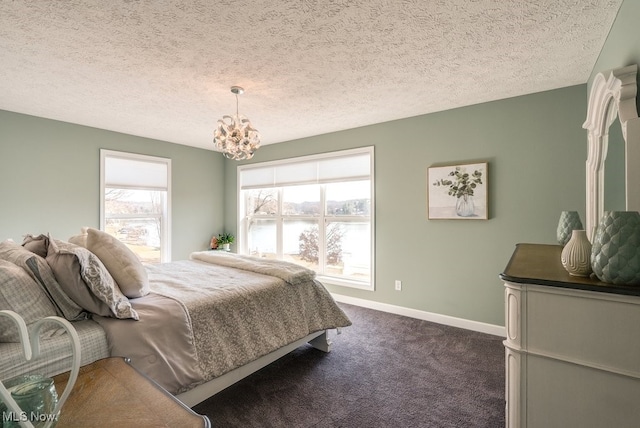 bedroom with baseboards, a notable chandelier, dark carpet, and a textured ceiling