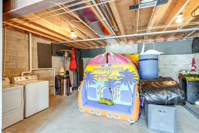 unfinished basement with washing machine and clothes dryer