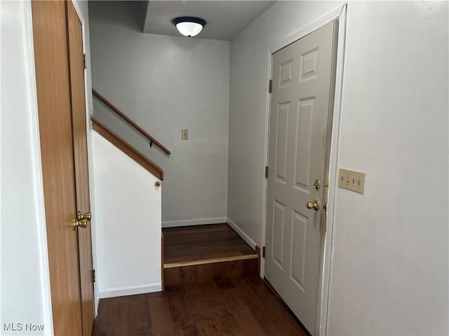 entryway featuring baseboards and wood finished floors