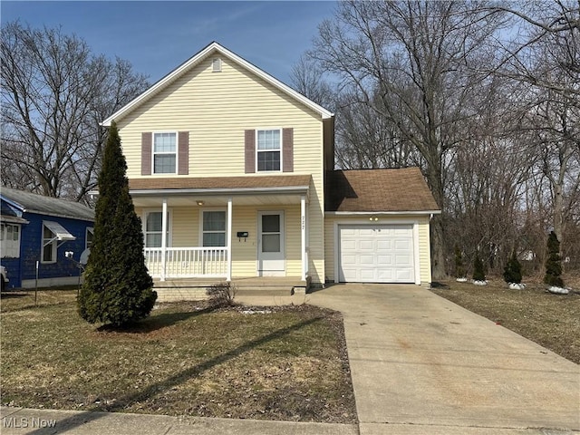 traditional home with concrete driveway, a garage, and covered porch