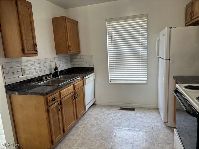 kitchen with visible vents, backsplash, electric stove, white dishwasher, and a sink