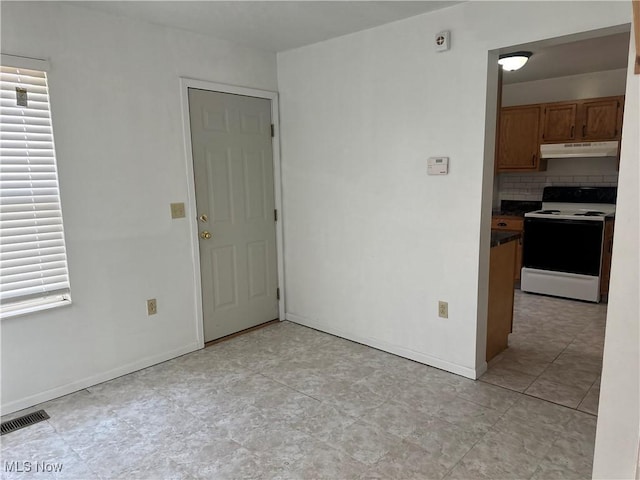 unfurnished room with visible vents and baseboards