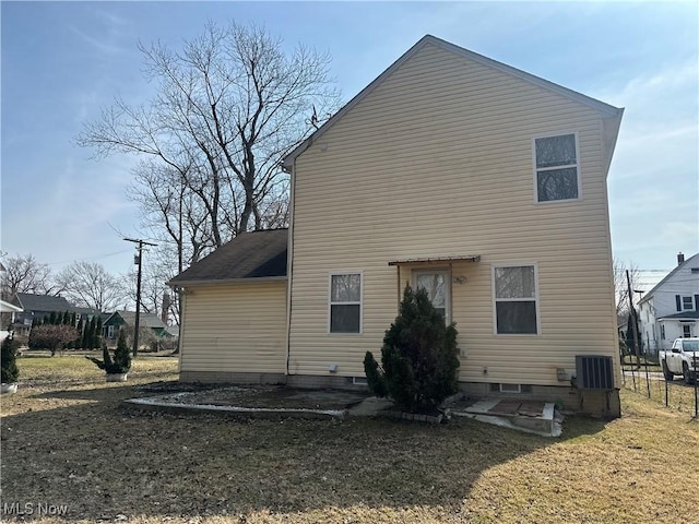 back of property featuring central air condition unit and fence