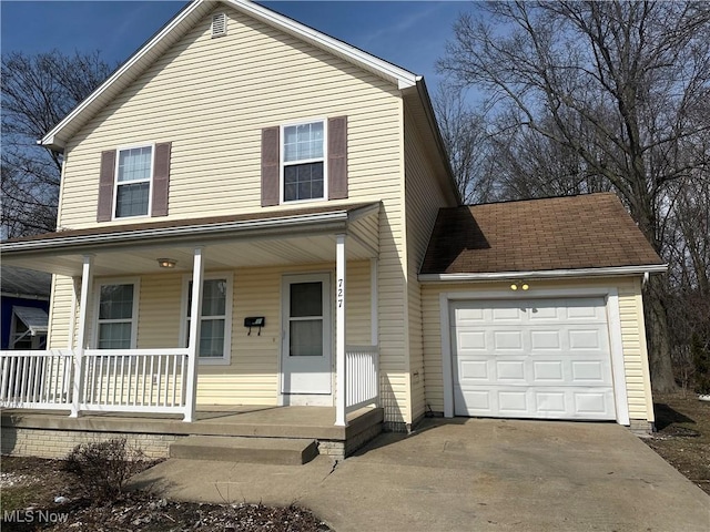 view of front facade featuring an attached garage, covered porch, and driveway