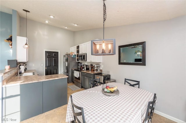 dining area with lofted ceiling, light tile patterned floors, recessed lighting, and baseboards