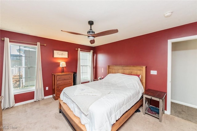 carpeted bedroom featuring baseboards and ceiling fan