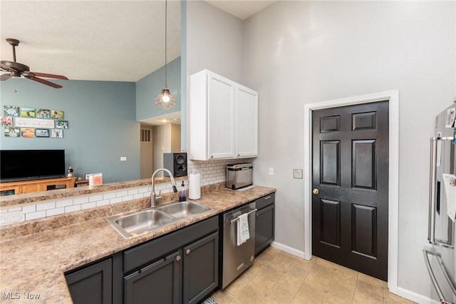 kitchen featuring ceiling fan, decorative backsplash, a sink, white cabinets, and dishwasher