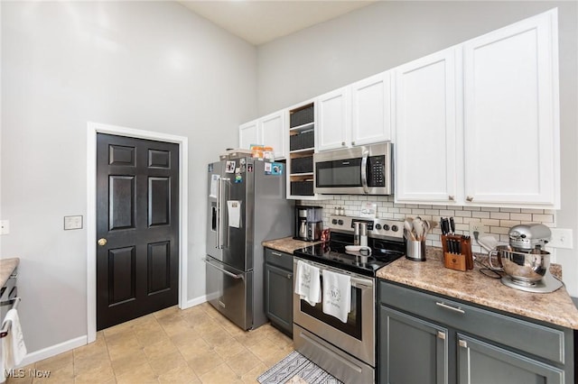 kitchen with tasteful backsplash, appliances with stainless steel finishes, and white cabinets