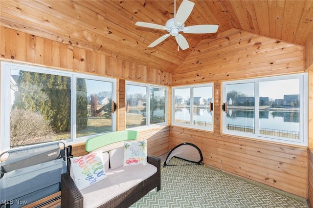 sunroom / solarium featuring ceiling fan, wood ceiling, lofted ceiling, and a water view