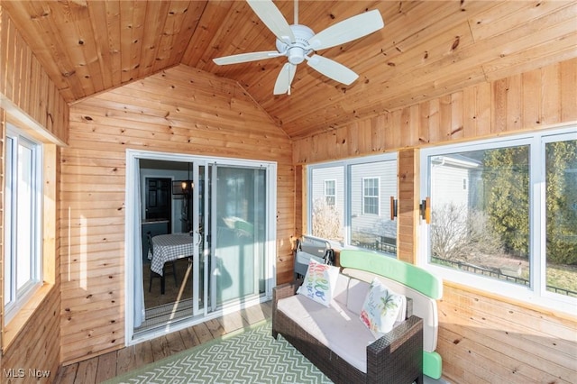 sunroom / solarium featuring wood ceiling, lofted ceiling, and a healthy amount of sunlight