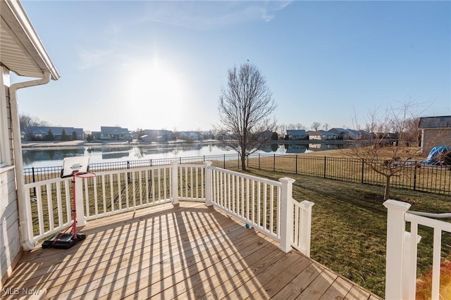 wooden deck with a water view and a fenced backyard