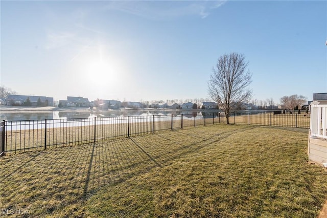 view of yard featuring fence and a water view