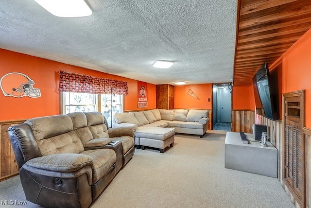 carpeted living area with a textured ceiling