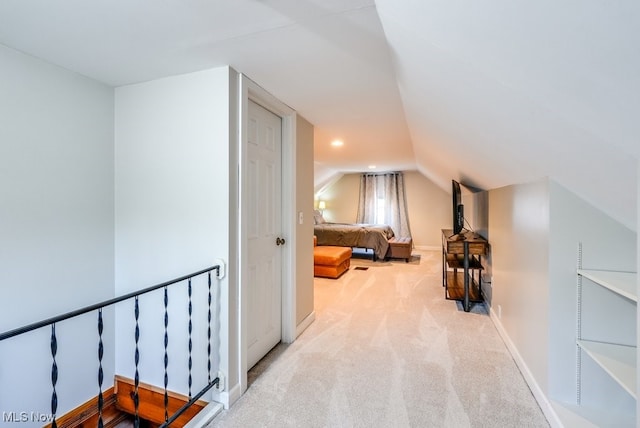 corridor with recessed lighting, baseboards, light colored carpet, and lofted ceiling