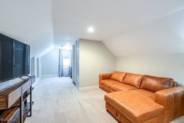 living area featuring light colored carpet, baseboards, and vaulted ceiling