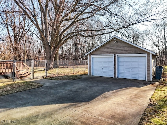 detached garage featuring a gate and fence