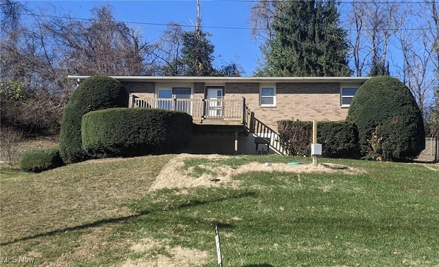 ranch-style home with stairway, brick siding, a deck, and a front lawn