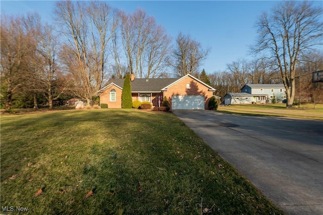 view of front of house featuring an attached garage, a chimney, driveway, and a front lawn