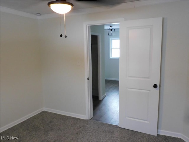 empty room featuring carpet flooring and baseboards