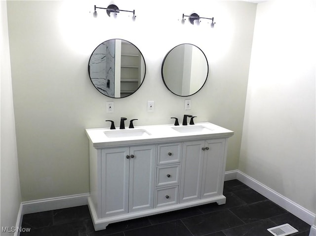 full bath featuring a sink, visible vents, and baseboards