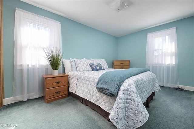 carpeted bedroom with multiple windows and baseboards