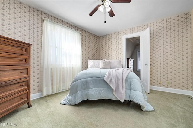 bedroom with wallpapered walls, baseboards, and light carpet