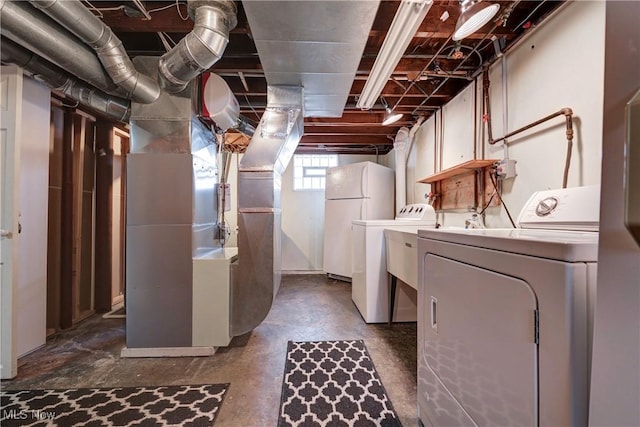 laundry area with heating unit, laundry area, and washer and dryer