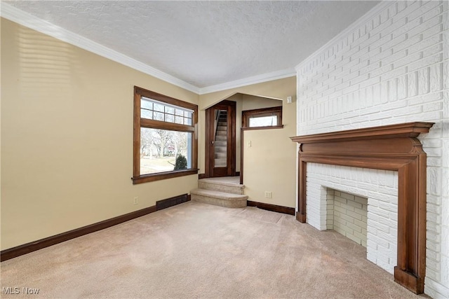 unfurnished living room featuring baseboards, a textured ceiling, crown molding, and carpet