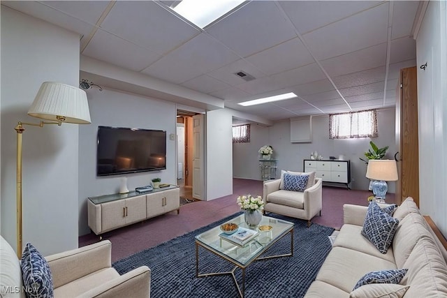 carpeted living room featuring visible vents and a drop ceiling