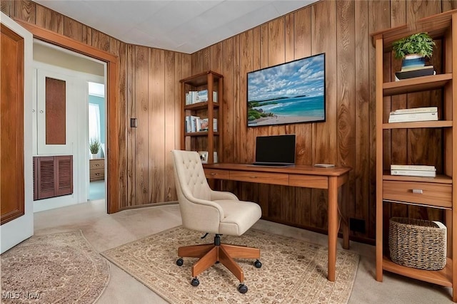 home office featuring wooden walls, carpet flooring, and visible vents