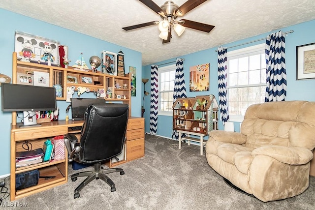 carpeted office space featuring a textured ceiling and ceiling fan