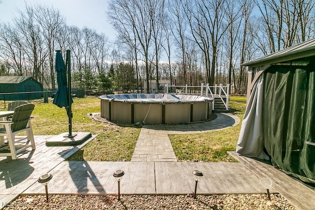 view of yard with a fenced in pool and fence